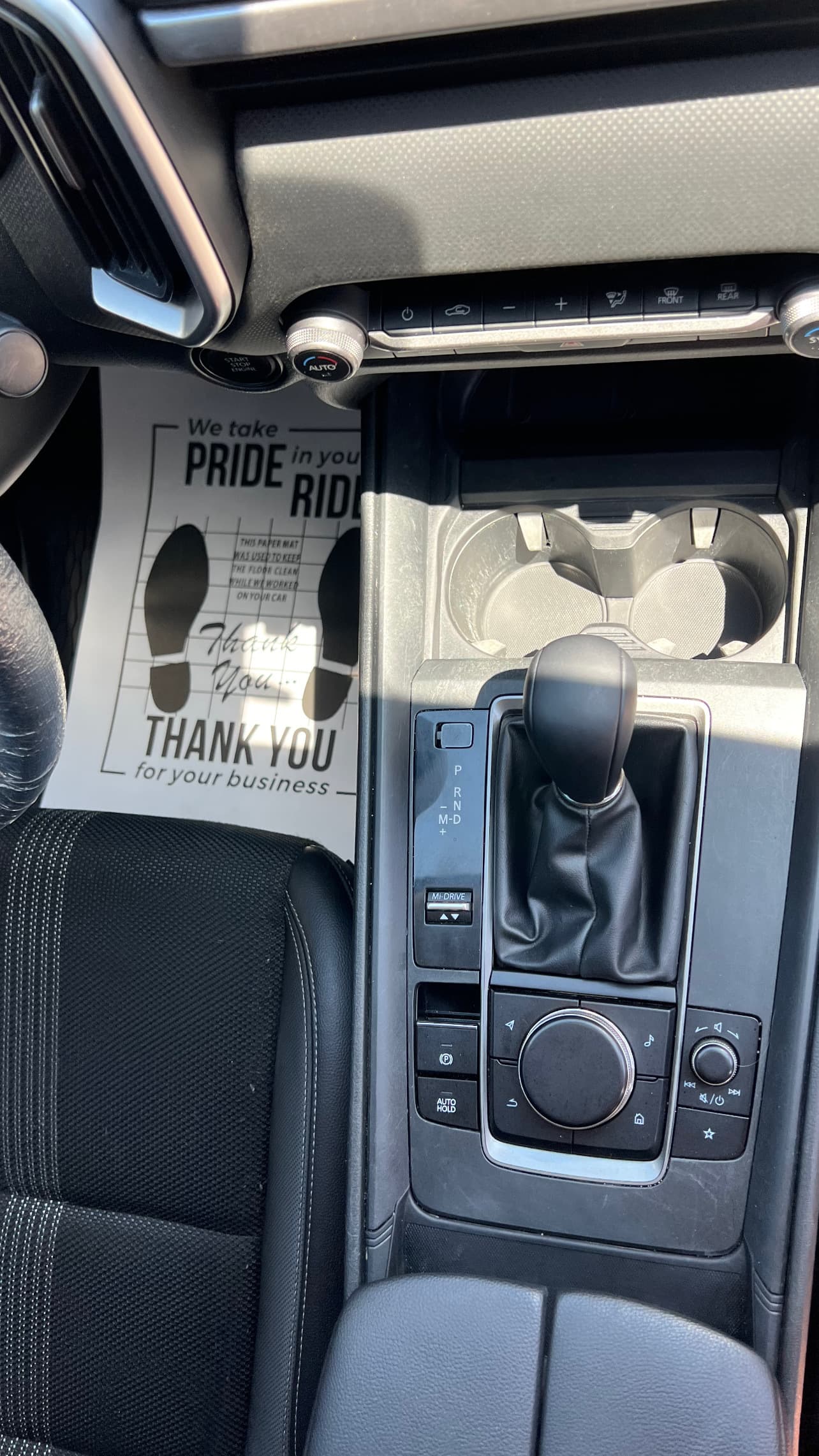 Before detailing - dirty car interior console with debris and dust in Loveland, Colorado